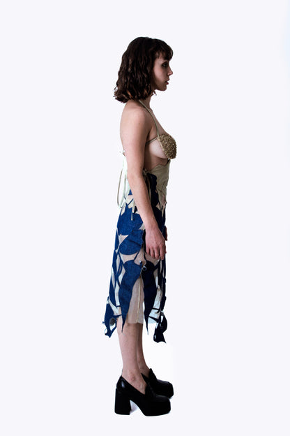 Woman wearing a denim dress with a white background